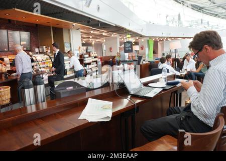 DUSSELDORF - SEPTEMBER 16: Starbucks cafe interior in airport on September 16, 2014 in Dusseldorf, Germany. Dusseldorf Airport is the international ai Stock Photo