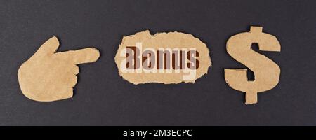 Economy and finance concept. On a black surface, a figure of a hand, a dollar symbol and a torn cardboard with the inscription - Bonus Stock Photo