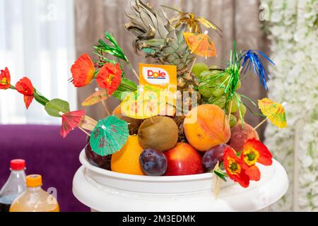 Many different sweet ripe fruits on the festive table in a fruit vase Stock Photo