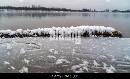 Frozen snow-white crystals of water on a pond Stock Photo