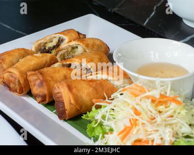 Deep fried spring rolls with mushrooms and glass noodles, a typical East and Southeast Asian appetizer. Stock Photo
