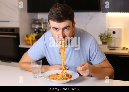 Man eating pasta with bad manners Stock Photo