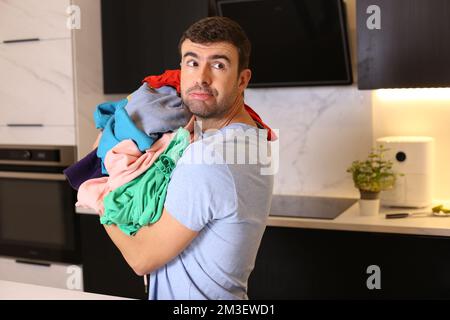 Cute man doing the laundry Stock Photo