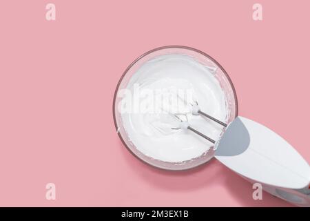 Electric mixer whisking egg whites in a glass bowl Stock Photo - Alamy