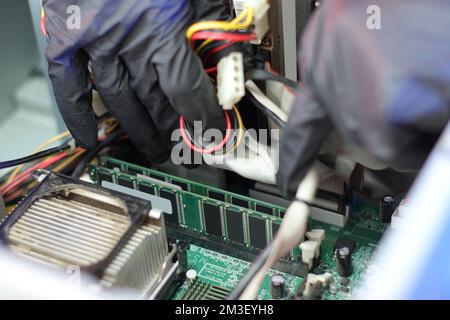 ram memory on the motherboard in an old computer under the cables Stock Photo