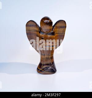 Carved Tigers Eye figure of an Angel Stock Photo