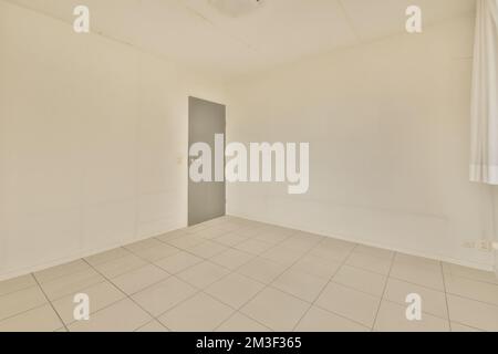 an empty room with white tiles on the floor and light coming in through ...