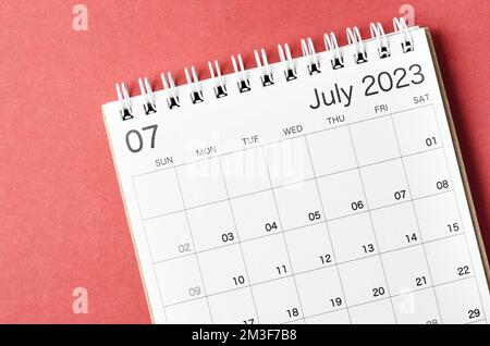 July 2023 calendar desk for the organizer to plan and reminder isolated on red background. Stock Photo