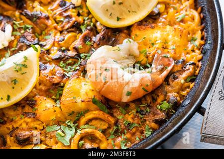 Close-up of typical delicious spanish paella with seafood in serving size Stock Photo