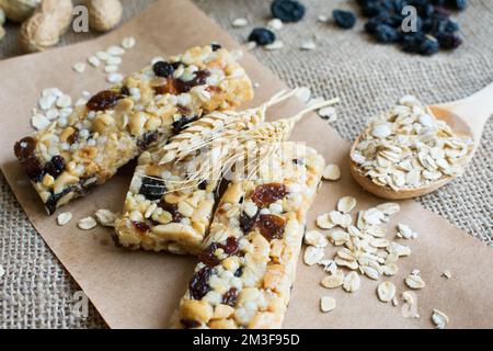 Granola bars, peanuts, oats, grapes, healthy nutrition vegetarian snack, close-up. Stock Photo