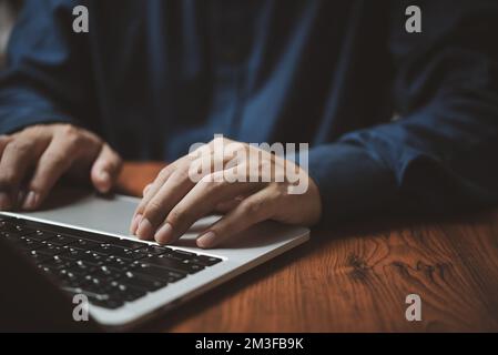 Man hands typing on laptop keyboard at the office. Stock Photo