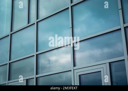 Clouds reflecting in the fragment facade of a modern building Stock Photo