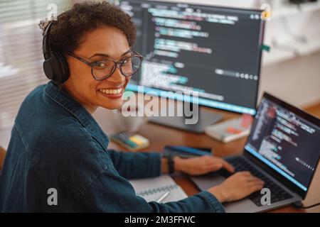 Female freelancer making new project as web designer and programmer on her computer at home office Stock Photo