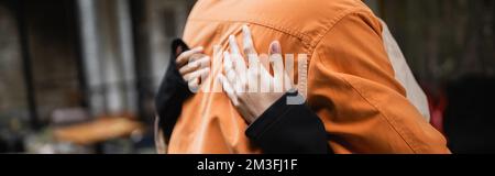 Cropped view of woman hugging boyfriend in outdoor cafe, banner,stock image Stock Photo