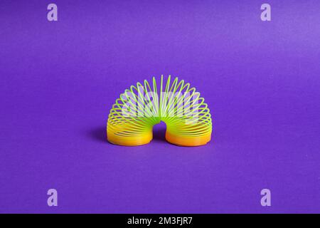 Fun Spiral Plastic Toy; Photo On Blue Background. Stock Photo