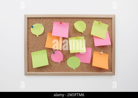 colorful post it note papers on cork board Stock Photo