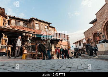 Ankara-Turkey, December 09, 2022: People shopping at the bazaar in Ankara Kaleici, old settlement area inside Ankara Castle. Famous ancient wooden hou Stock Photo