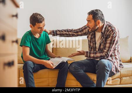 Father is helping his son with learning. Boy is having problem with homework. Stock Photo