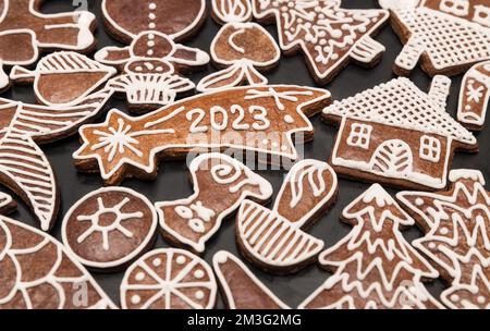 Beautiful gingerbread for happy New Year 2023 in Bethlehem star shape among ornate Xmas sweets. Close-up of baked aromatic handmade Christmas cookies. Stock Photo