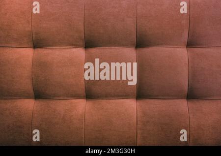 Brown suede leather background for the wall in the room. Interior design, headboards made of furniture fabric, furniture upholstery. Classic checkered Stock Photo