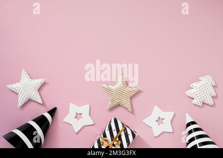Christmas composition. Christmas gifts, black and golden decorations on pastel pink background. Stock Photo
