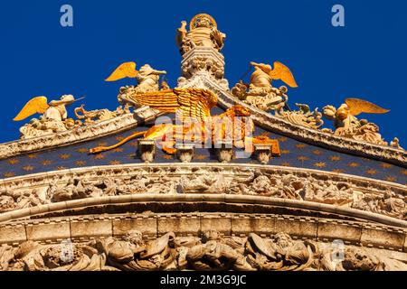 Gilded God the Father with angels and St. Marks lion on the gable of St. Marks Basilica, Venice, Italy Stock Photo