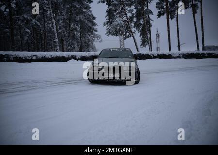 12-12-2022 Riga, Latvia  a car is parked on a snowy road in the snow. . Stock Photo