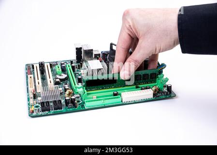 Installing a new RAM DDR memory for a personal computer processor socket in a service. Upgrade repair. PC upgrade or repair concept. Isolated Stock Photo