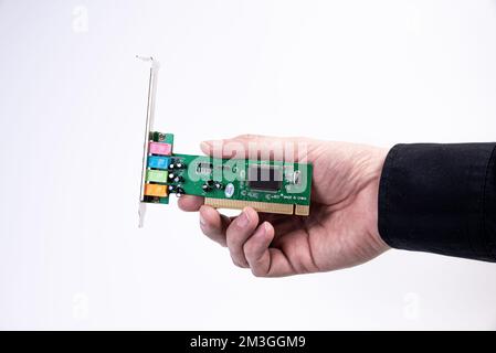 Engineer repairman holding hands in black gloves chip processor, CPU to insert into the socket of the computer motherboard. The concept of technology Stock Photo
