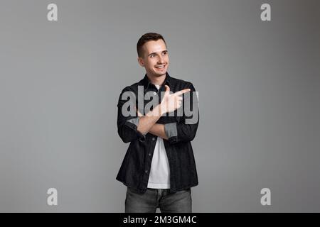 Young handsome man pointing to the side copy space Stock Photo