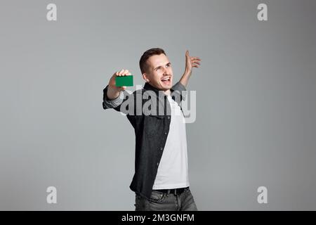 young man holding a credit bank card Stock Photo