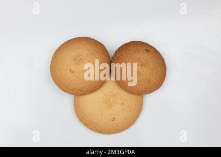 A row of three ginger biscuits,round cookies isolated on white background. Stock Photo