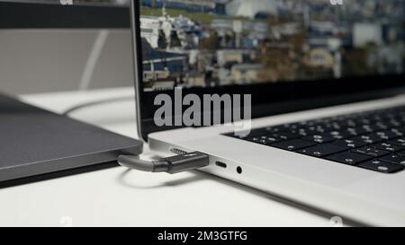 The concept of working on a computer. Action . A new laptop with working connectors and showing a good monitor that turn on for work. High quality 4k Stock Photo
