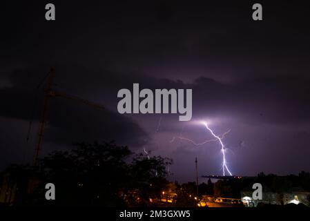Panoramic view of a storm cloud illuminated by lightning flashes Stock Photo