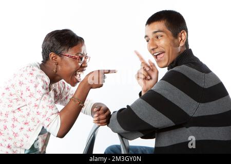 Teenage Students: Carefree Friends. A pair of happy late-teenage friends facing each other in a playful mood. From a series of related images. Stock Photo