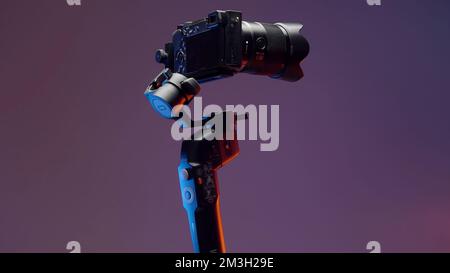 The concept of shooting with gadgets. Action.A large swivel tripod on which a large video camera is attached shoots in different directions on a brigh Stock Photo