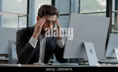 Tired Caucasian bearded 40s middle-aged businessman employee man typing laptop feel failure upset with lost of information online error stressed look Stock Photo