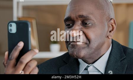Closeup male portrait African American 50s old middle-aged businessman emotional professional man online remote conversation manager worker looking in Stock Photo
