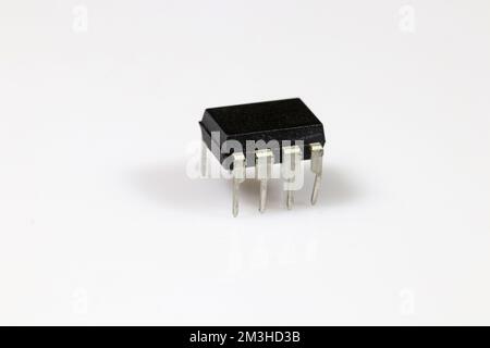 Microcontroller witrh eight pins (legs) on white background. Electronic components. Stock Photo