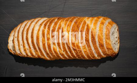 Top view of slices of white bread on wooden chopping board, panoramic shot Stock Photo