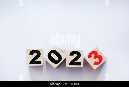 A cube made of wooden blocks with the text 2023 for change and preparation for a merry christmas and a happy new year. Stock Photo