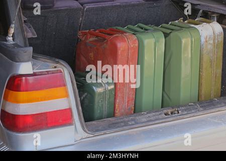 Cans of gasoline in the trunk of a car. Lack of petrol at gas stations. Stock Photo