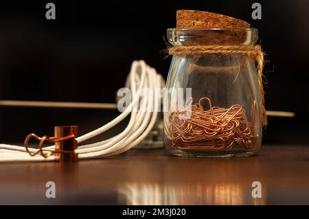 Jar with paper clips on the table Stock Photo