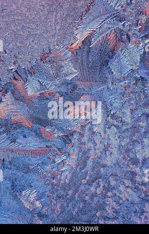 Winter Icy and Frosty Patterns on the Window Glass.  Background for Christmas and New Year. Macro Close Up Stock Photo