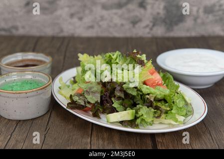 Healthy appetizer for Indian cuisine is a mixed garden saled with  traditional humus dipping sauce Stock Photo - Alamy