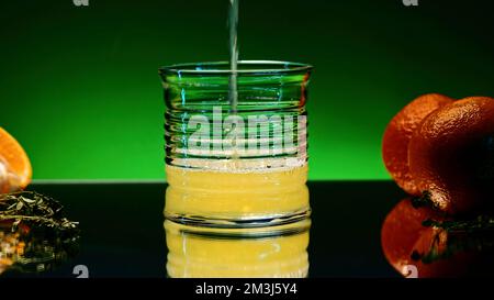 Refreshing colorful drink in a transparent glass. Stock clip. Prepared juciy cocktail at the night club party Stock Photo