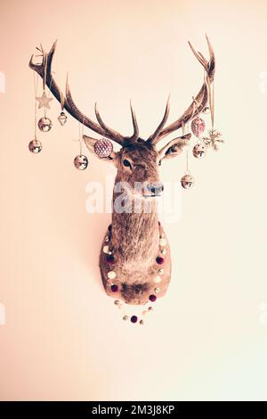 stag decorated with Christmas ornaments. High quality photo Stock Photo