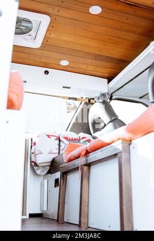 Beautiful bright natural light entering and illuminating an old self converted minivan campervan for van life. The vanlife recreational vehicle has or Stock Photo