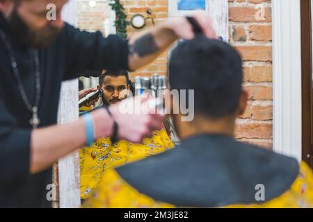 man getting a new haircut at the barbershop, back view medium shot . High quality photo Stock Photo