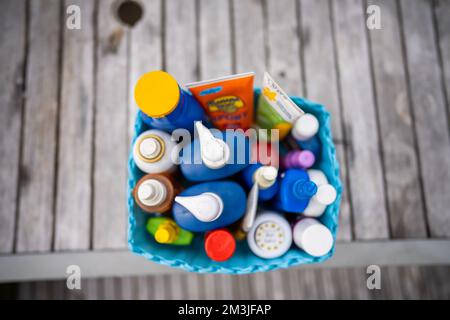 container of sunscreen, buy spray and summer lotions in summer australia in spring Stock Photo